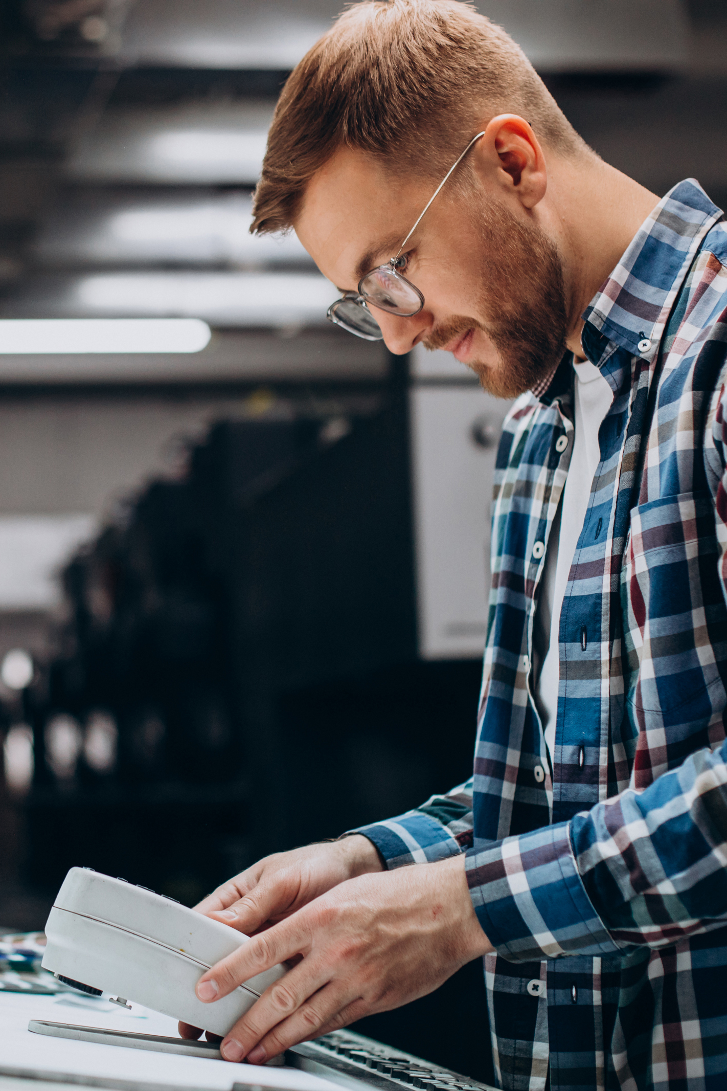 Man working in printing house with paper and paints